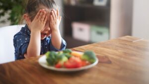 My kid hates eating _____.